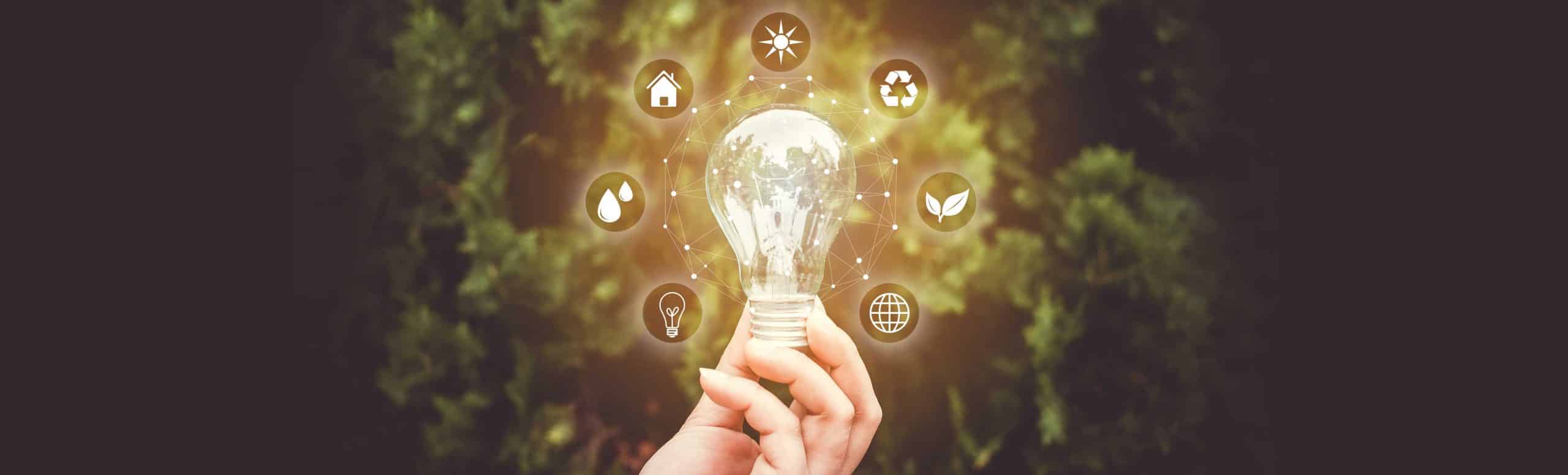 Hand holding glowing lightbulb with surrounding lifestyle icons