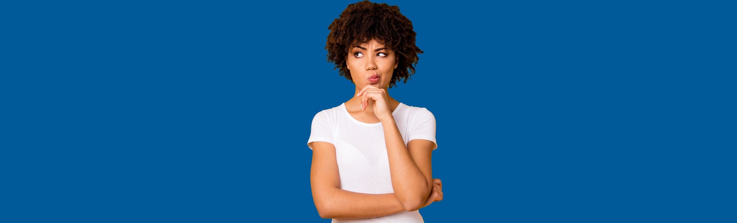 Woman with crossed arms and her hand on her contemplating