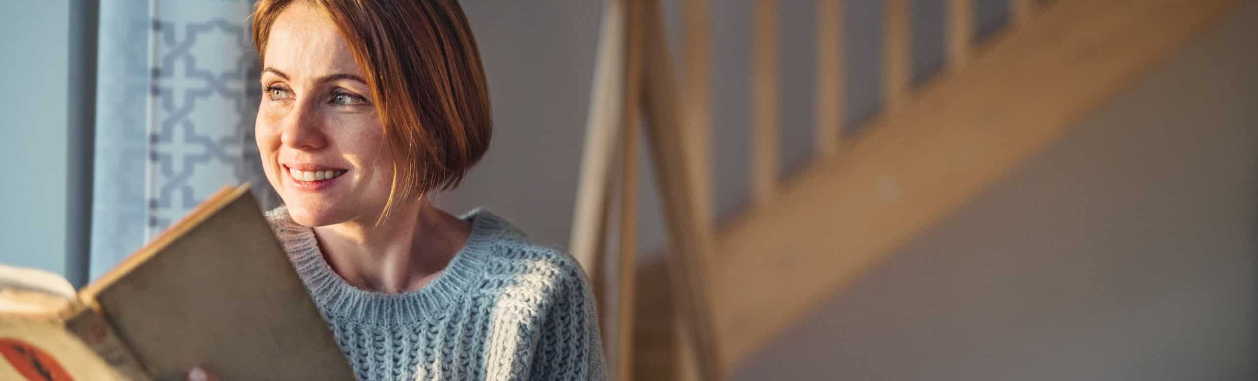 woman reading by the windowsill