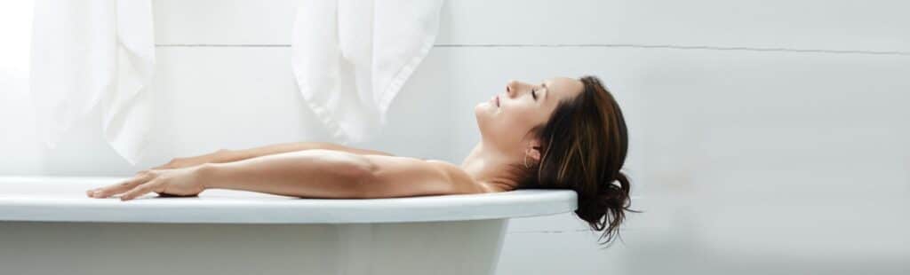 Person laying in a warm bathtub