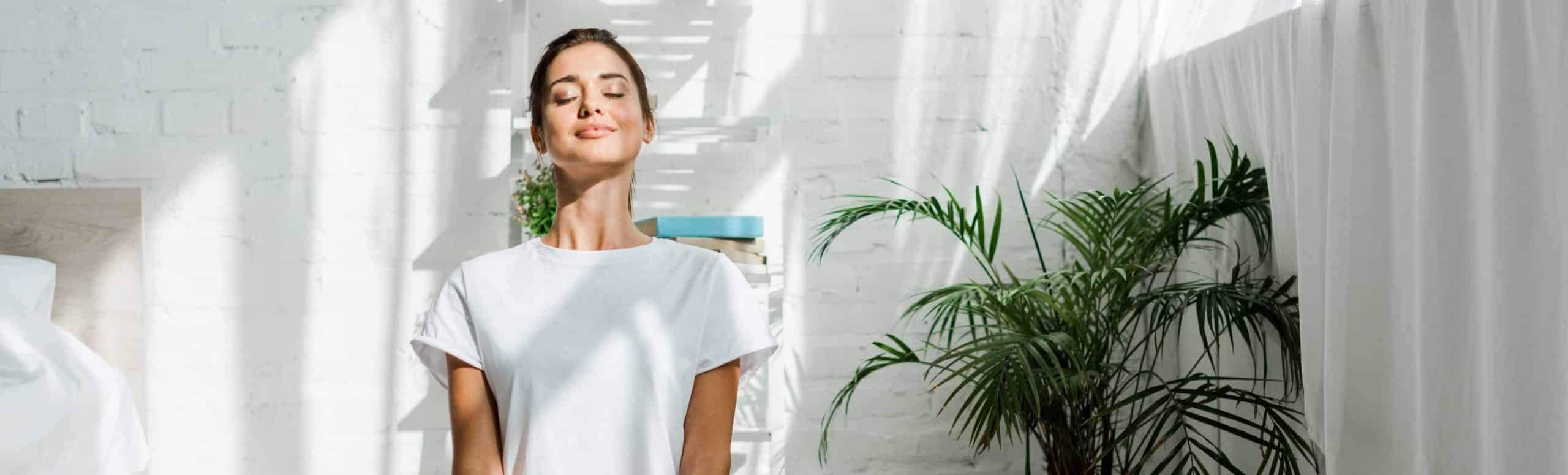 Person sitting up straight and cross legged on a carpet