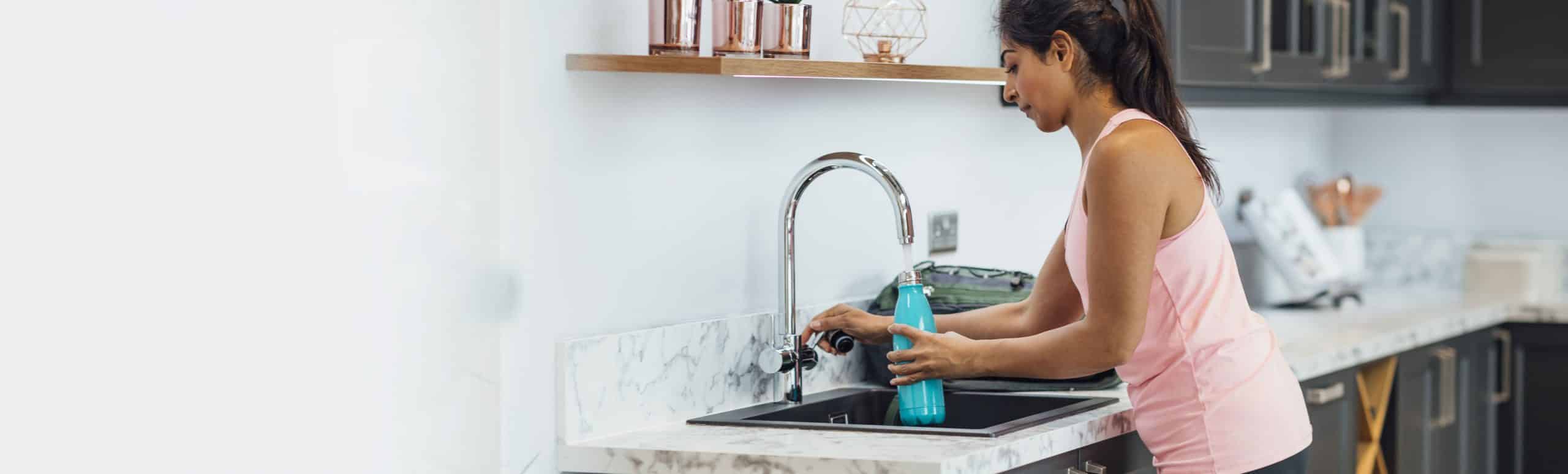 A reliance employee setting the thermostat at home