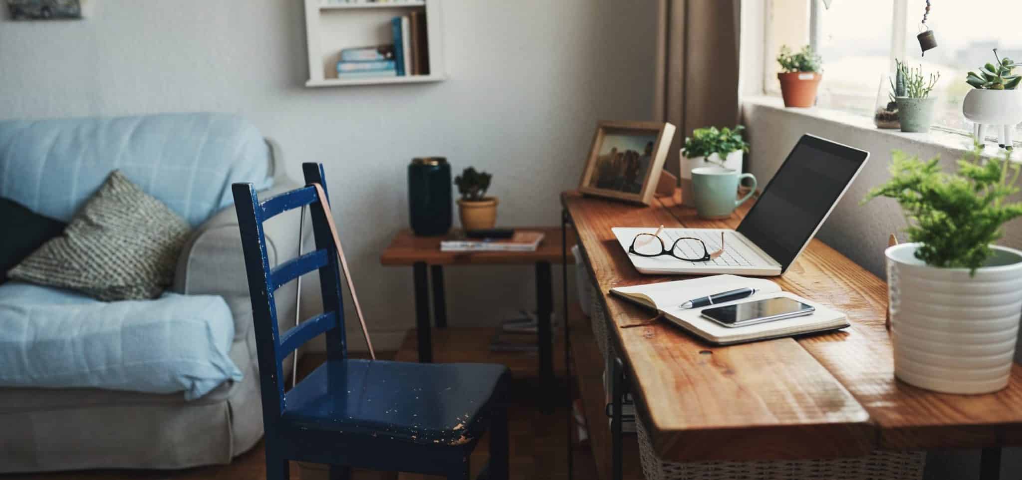 Desk at home with computer and book open