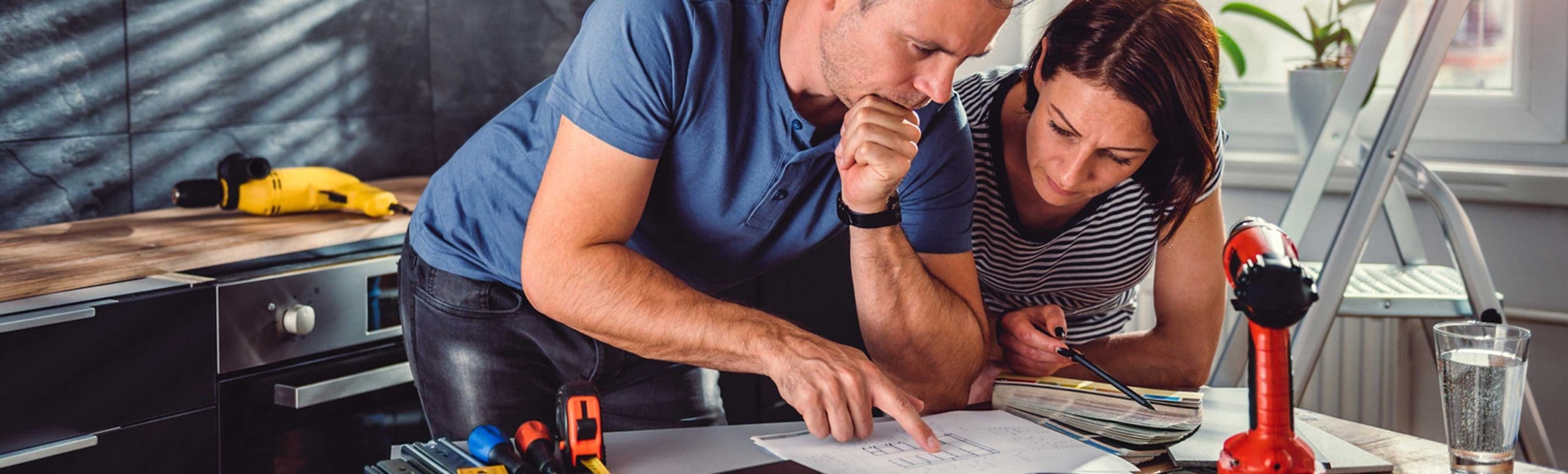 Man and woman looking at checklist in the kitchen